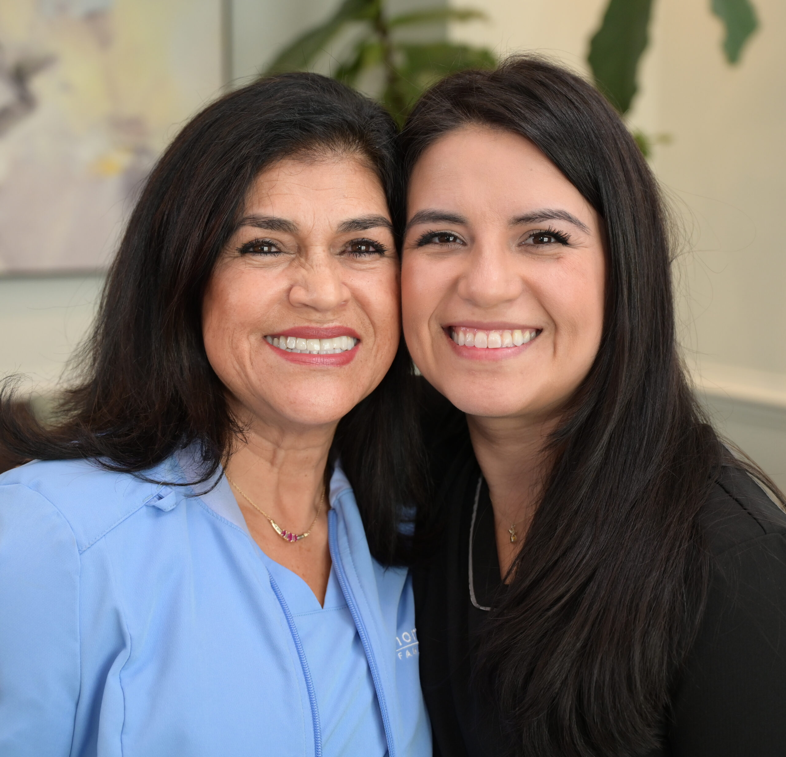 Dr. Dani Vargas, dentist and Martha Vargas, dental assistant of North Atlanta Family Dentistry smiling together with their face stick to each other - North Atlanta Family Dentistry Dr. Dani Vargas, dentist and Martha Vargas, dental assistant of North Atlanta Family Dentistry smiling together with their face stick to each other - North Atlanta Family Dentistry