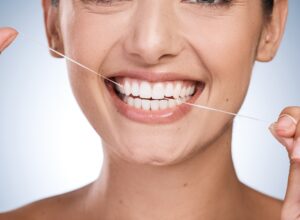 woman flossing her teeth