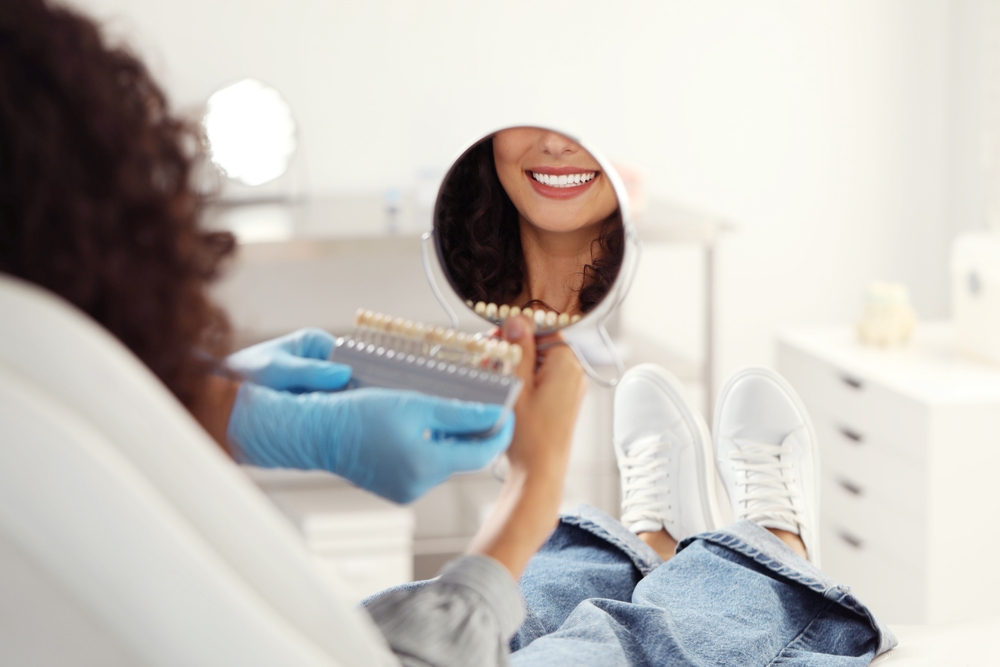 A woman checking her teeth - Cosmetic Dentist in Johns Creek
