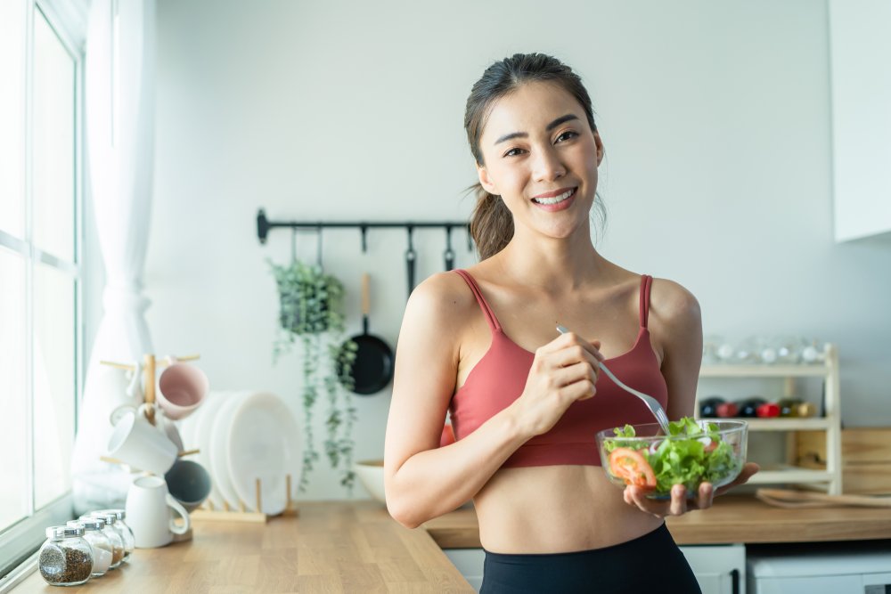 fit woman eating salad