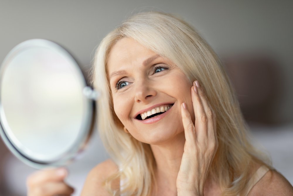 elderly woman looking at her teeth
