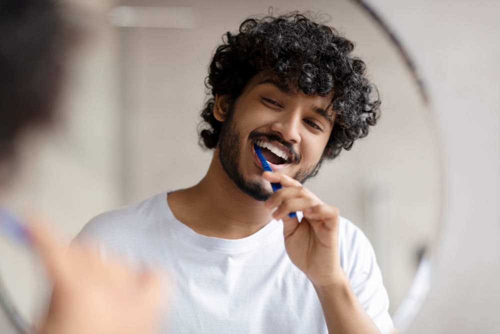 Mediterranean man brushing his teeth