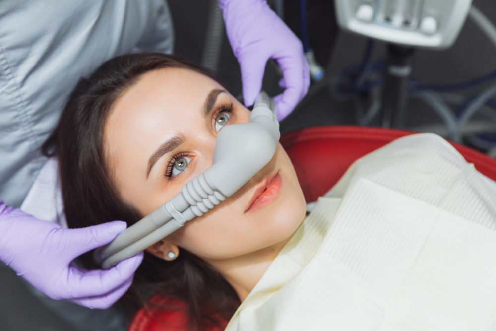 A dental professional in protective gear prepares a patient for a 3D dental X-ray scan using specialized equipment - North Atlanta Family Dentistry