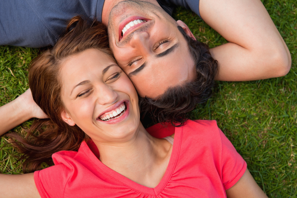 a young couple lying on the grass