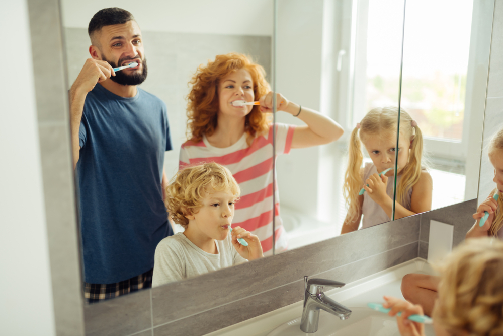 A family brushing their teeth