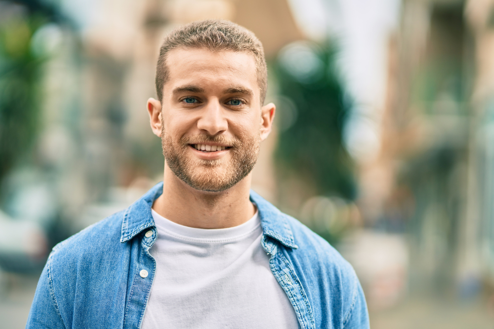 man outdoors smiling