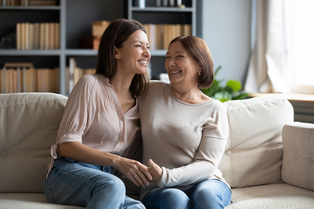 mother and daughter sitting at the sofa