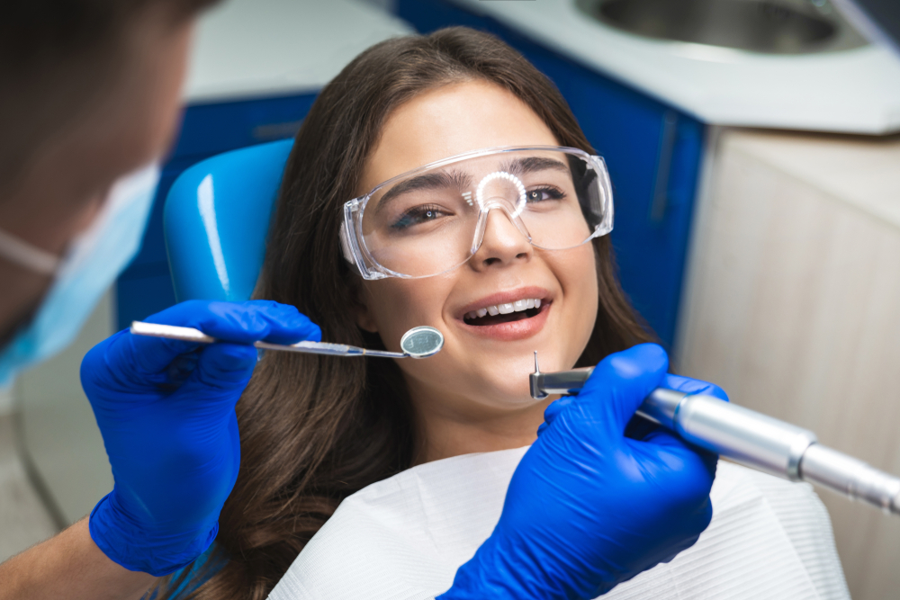 A brunette woman at the dentist - Teeth Cleaning in Cumming
