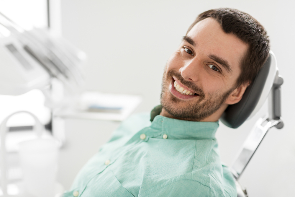 a man sitting at a dental chair