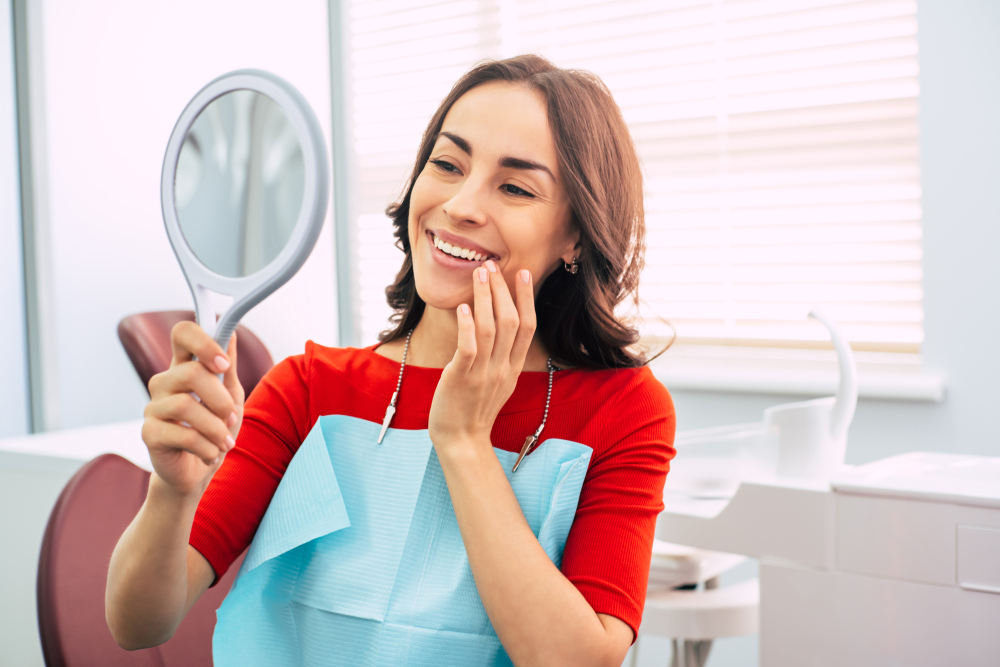 woman checking her teeth in the mirror